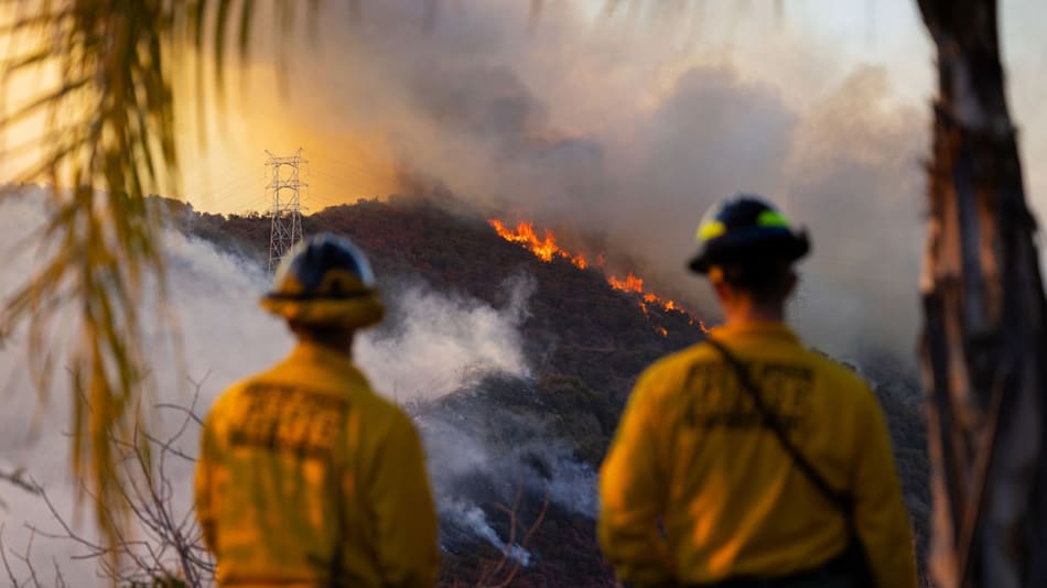 Firefighters with fire in background
